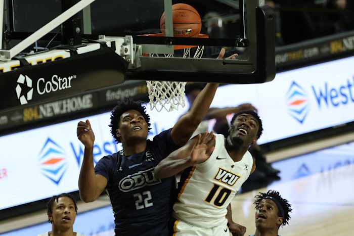 Dec 12, 2020; Richmond, Virginia, USA; VCU Rams forward Vince Williams Jr. (10) tips in a rebound as Old Dominion Monarchs forward Kalu Ezikpe (22) defends in the first half at Stuart C. Siegel Center. Mandatory Credit: Geoff Burke-USA TODAY Sports